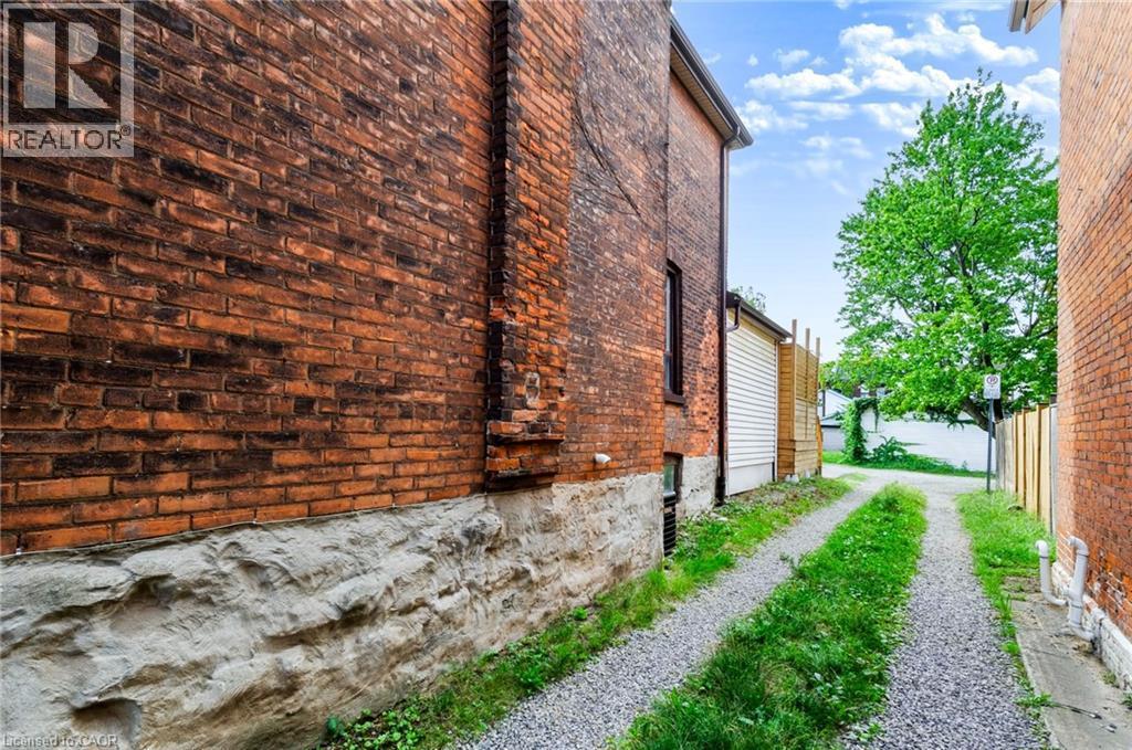 Brick exterior with a stone foundation - 34 Baillie Street, Hamilton, ON
