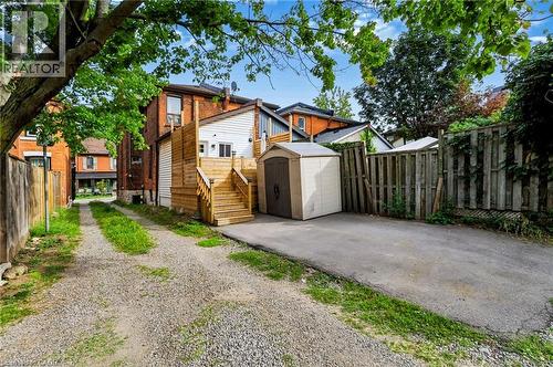 Rear exterior with wood decking and staircase - 34 Baillie Street, Hamilton, ON 