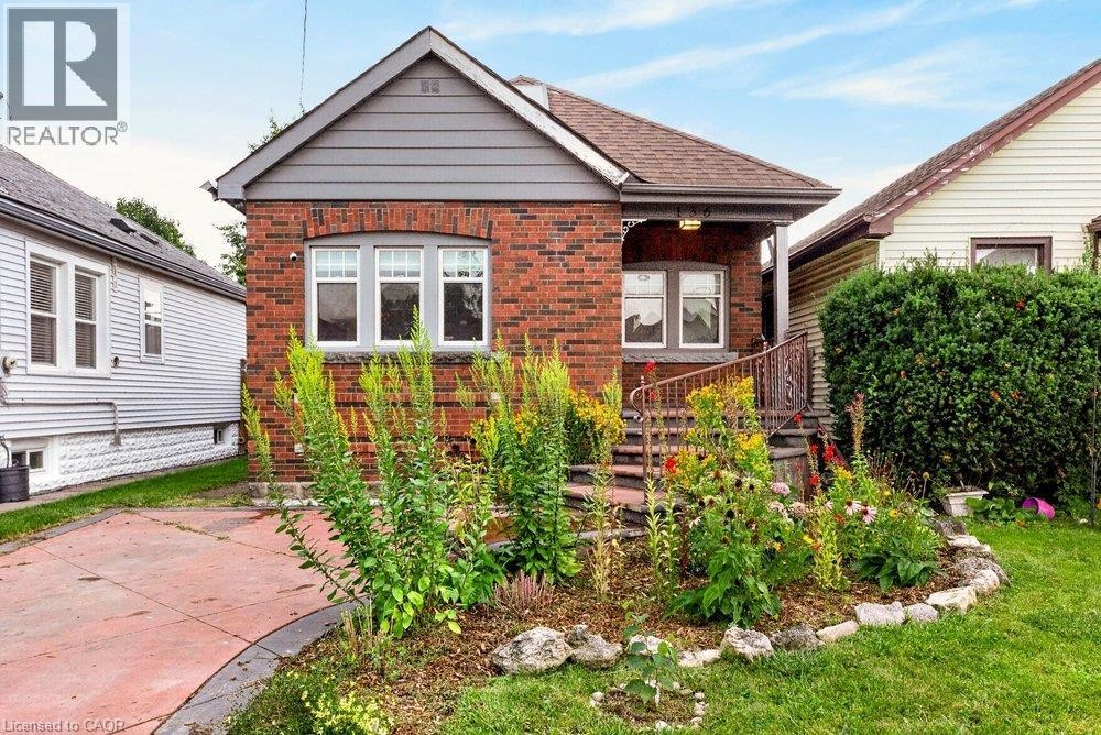 Brick exterior with gray siding accents - 136 Weir Street N, Hamilton, ON