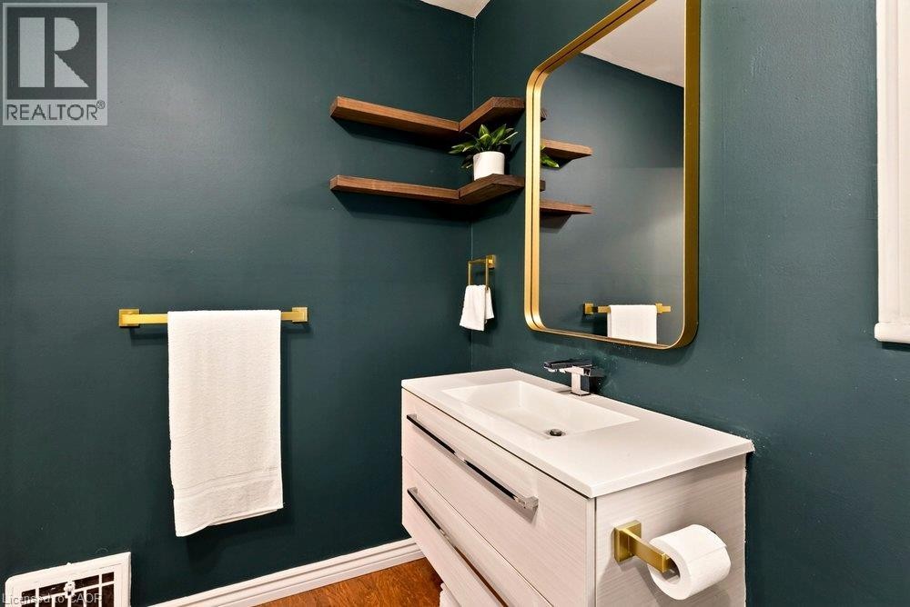 Wall-mounted vanity with integrated sink, and wood-finish shelving - 136 Weir Street N, Hamilton, ON