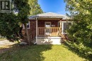 Brick exterior with a covered front porch featuring wood railings - 860 Garth Street, Hamilton, ON 