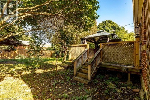 Wood deck with lattice railing, stairs, and a metal-framed gazebo - 860 Garth Street, Hamilton, ON 