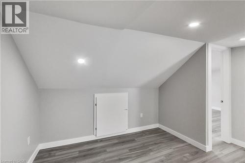 Recessed lighting, sloped ceiling, wood-finish flooring, built-in storage cabinet, and white trim - 229 Parkdale Avenue N, Hamilton, ON 