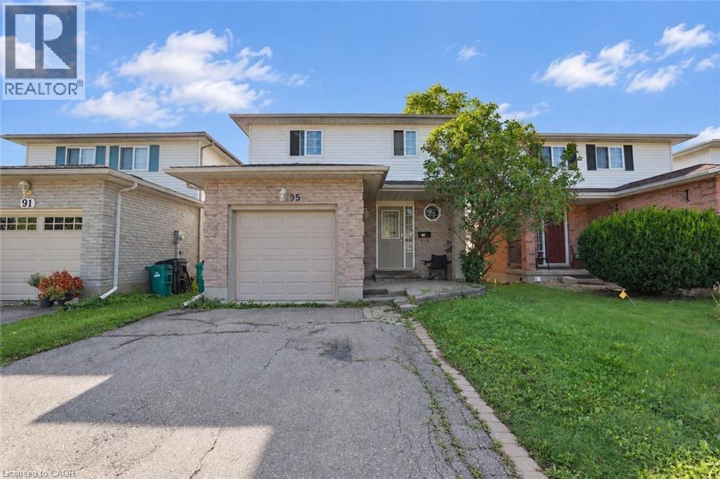 Two-story residential structure featuring a single-car garage, brick facade, and front lawn - 95 Resurrection Drive, Kitchener, ON