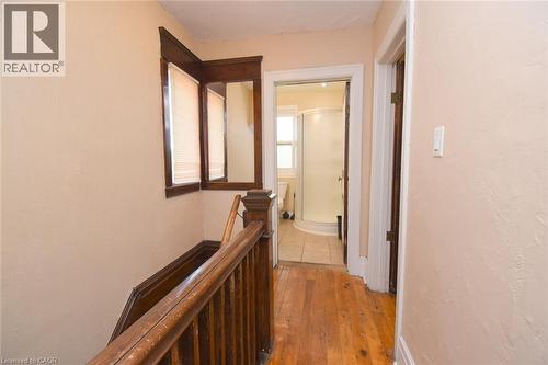 Wood-finish flooring throughout the hallway - 734 King Street W, Hamilton, ON 