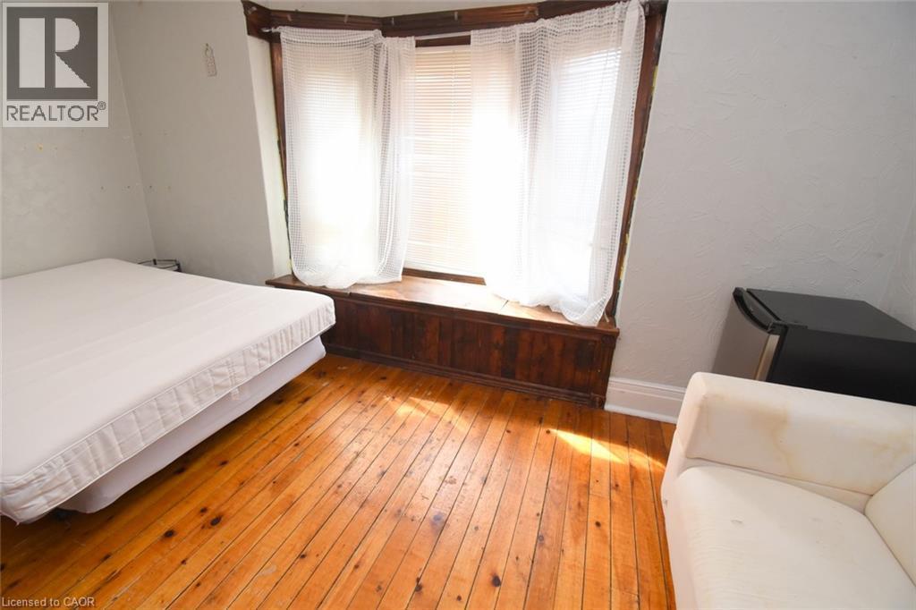 Bay window with wood trim, wood-finish flooring - 734 King Street W, Hamilton, ON