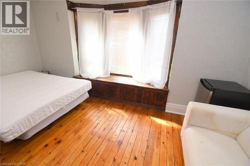 Bay window with wood trim, wood-finish flooring - 734 King Street W, Hamilton, ON 