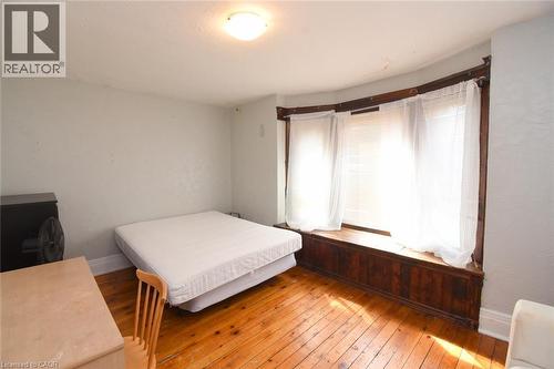 Hardwood flooring, curved bay window, built-in window seating, flush mount ceiling light - 734 King Street W, Hamilton, ON 