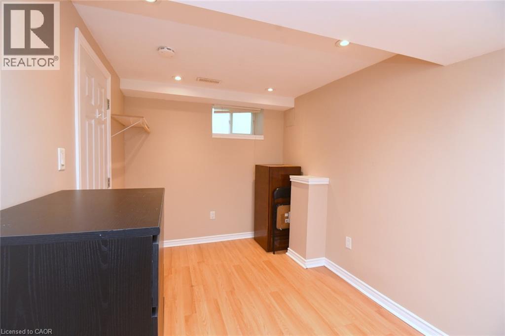 Recessed lighting illuminating wood-finish flooring - 734 King Street W, Hamilton, ON