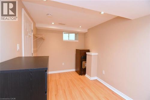 Recessed lighting illuminating wood-finish flooring - 734 King Street W, Hamilton, ON 