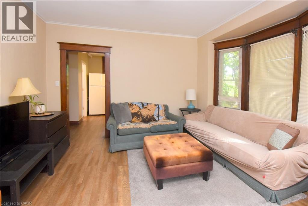 Warm neutral wall color with wood-finish flooring - 734 King Street W, Hamilton, ON