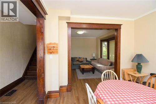 Hardwood-finish flooring, dark wood trim throughout, and a built-in staircase - 734 King Street W, Hamilton, ON 