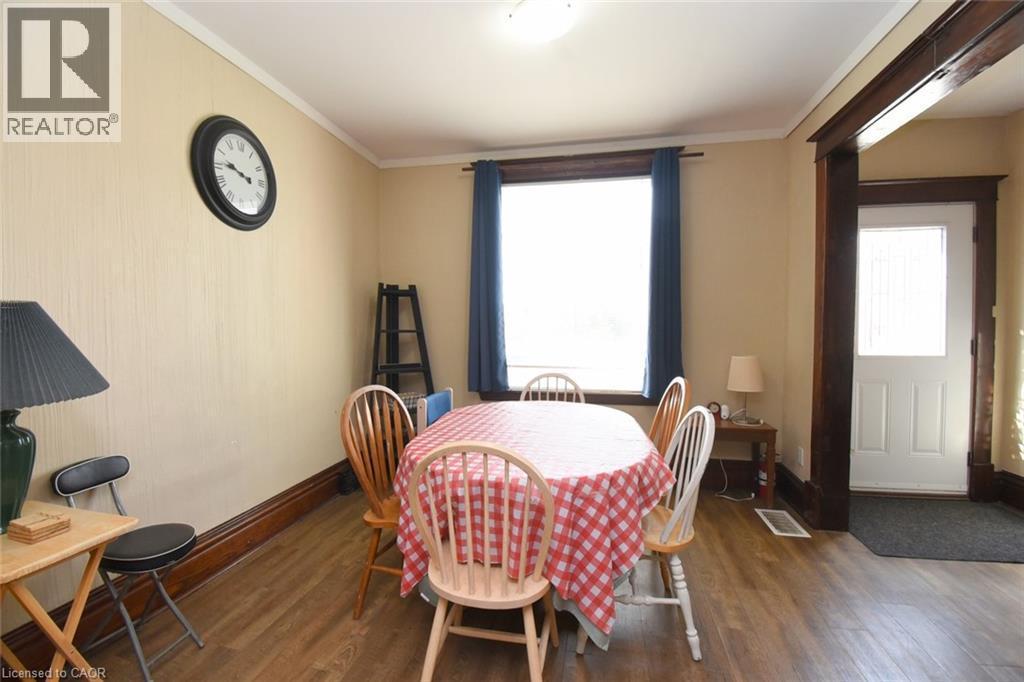 Wood-finish flooring, white ceiling, and a prominent window - 734 King Street W, Hamilton, ON