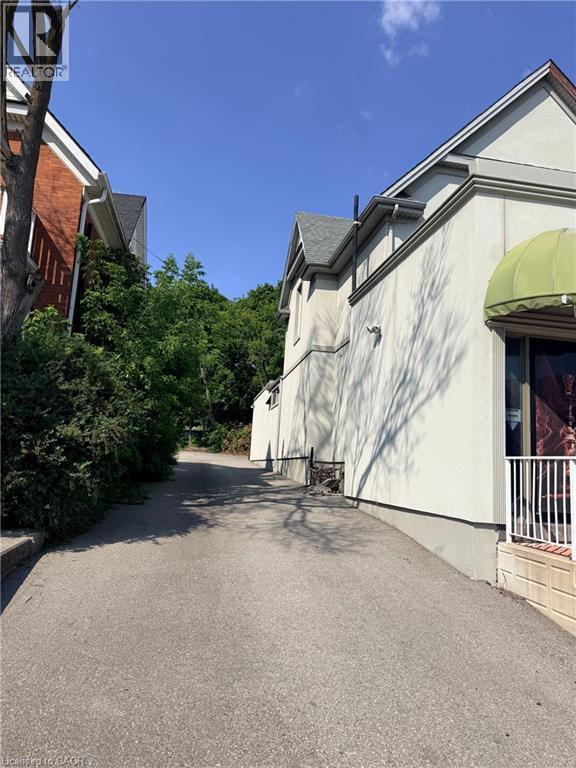 Paved driveway entry with stucco exterior - 612 King Street E, Kitchener, ON