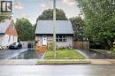 Gray shingle roof, light gray siding, white front door, wooden front steps, and a paved driveway - 102 Stewart Avenue, Cambridge, ON 
