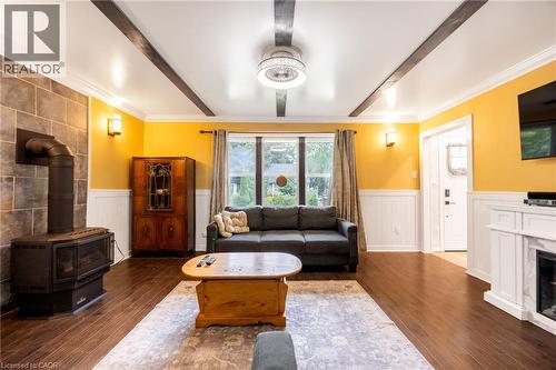 Hardwood-finish flooring, exposed ceiling beams, wainscoting, and a gas fireplace - 102 Stewart Avenue, Cambridge, ON 