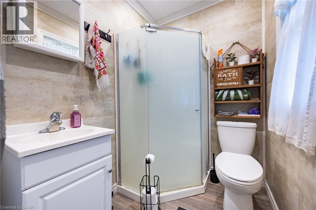 White vanity with an integrated sink and chrome faucet - 102 Stewart Avenue, Cambridge, ON