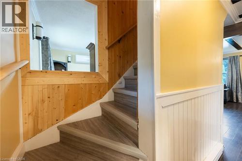 Wood-panel accent wall and staircase with wood-finish treads - 102 Stewart Avenue, Cambridge, ON 
