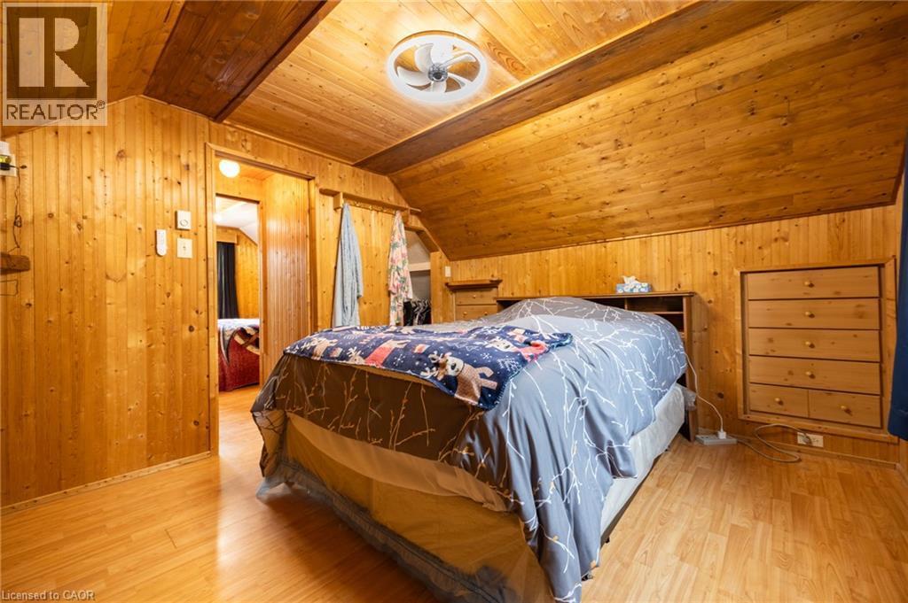 Wood-finish flooring with wood-paneled walls and sloped wood-finish ceiling - 102 Stewart Avenue, Cambridge, ON