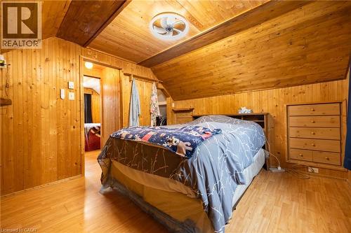 Wood-finish flooring with wood-paneled walls and sloped wood-finish ceiling - 102 Stewart Avenue, Cambridge, ON 