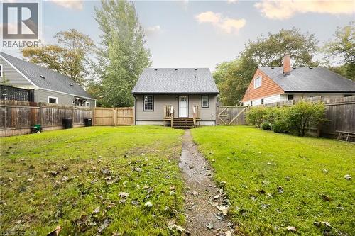 Expansive backyard featuring a manicured lawn, established privacy fencing, and mature trees - 102 Stewart Avenue, Cambridge, ON 