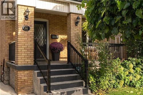 Brick facade with black exterior lighting fixtures - 50 Norway Avenue, Hamilton, ON 