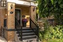 Brick facade with black exterior lighting fixtures - 50 Norway Avenue, Hamilton, ON 