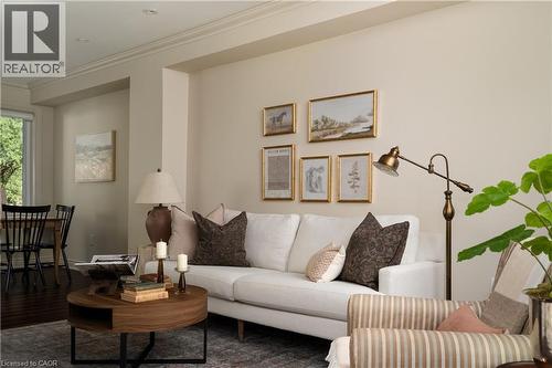 Recessed lighting, crown molding, wood-finish flooring, and a dining area with ample natural light - 50 Norway Avenue, Hamilton, ON 