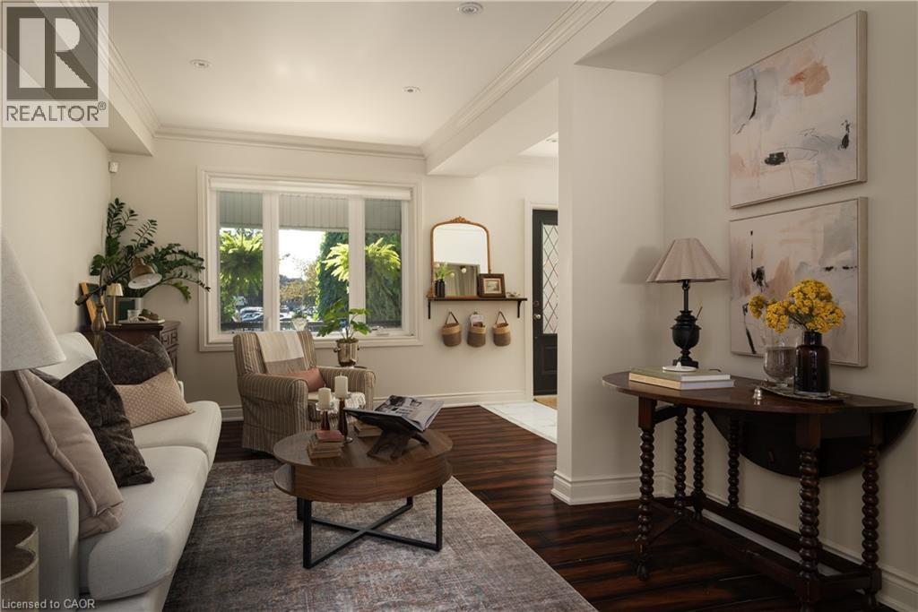 Dark wood-finish flooring complemented by white crown molding - 50 Norway Avenue, Hamilton, ON