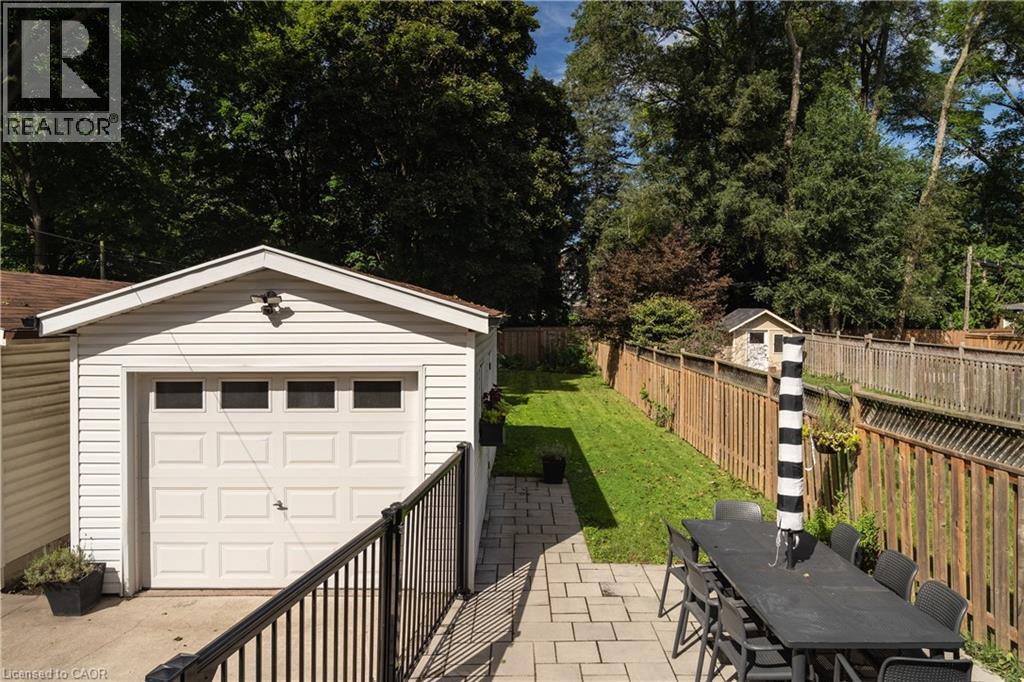 Spacious paver patio with a black metal railing - 50 Norway Avenue, Hamilton, ON