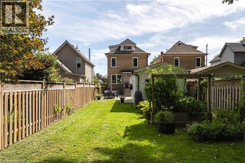 Expansive backyard featuring a manicured lawn, mature trees, and wooden fencing - 50 Norway Avenue, Hamilton, ON 