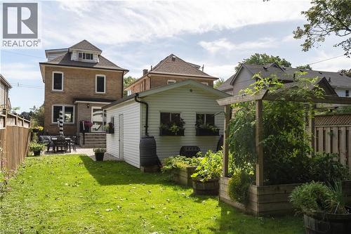 Expansive green lawn with a paver patio and an outdoor dining area - 50 Norway Avenue, Hamilton, ON 