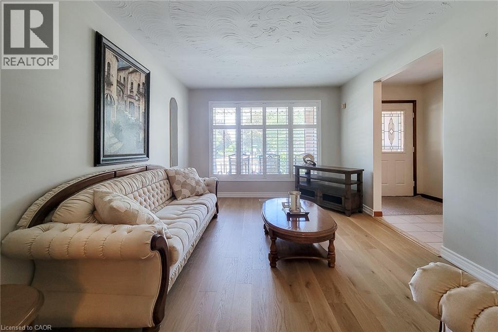 Hardwood-finish flooring, plantation shutters, and a decorative front door with leaded glass - 276 Greencedar Drive, Hamilton, ON
