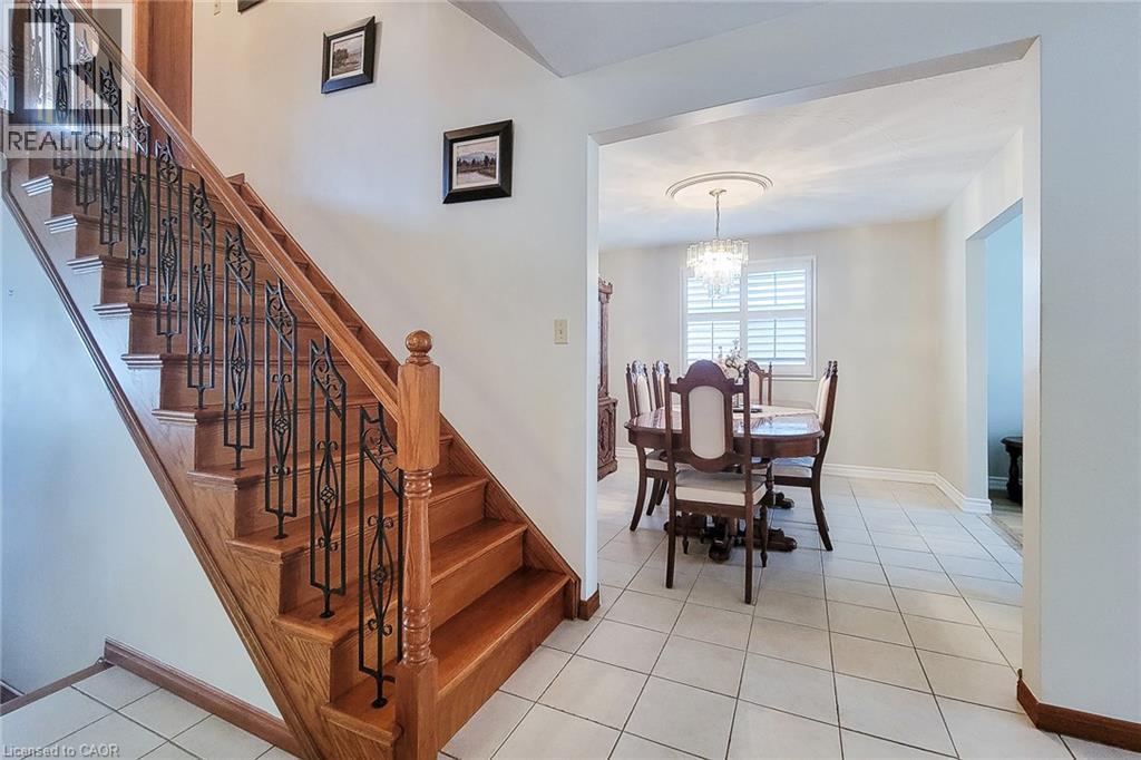 Hardwood staircase with decorative wrought iron spindles - 276 Greencedar Drive, Hamilton, ON