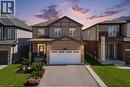 Brick and siding exterior with a covered entry, attached garage, and a paved driveway - 428 Freure Drive, Cambridge, ON 