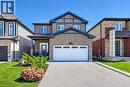 Brick and siding exterior with a two-car garage, covered entry, and landscaped front yard - 428 Freure Drive, Cambridge, ON 