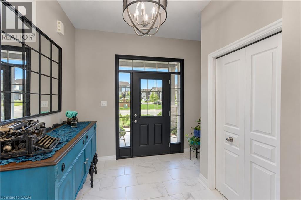 Entryway featuring tile flooring, a black front door with glass panels, and a ceiling-mounted light fixture - 428 Freure Drive, Cambridge, ON