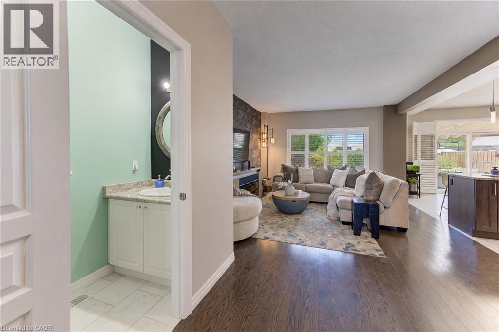 Powder room with vanity and round mirror - 428 Freure Drive, Cambridge, ON