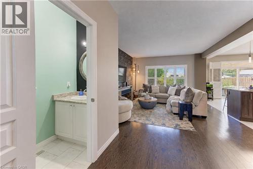 Powder room with vanity and round mirror - 428 Freure Drive, Cambridge, ON 