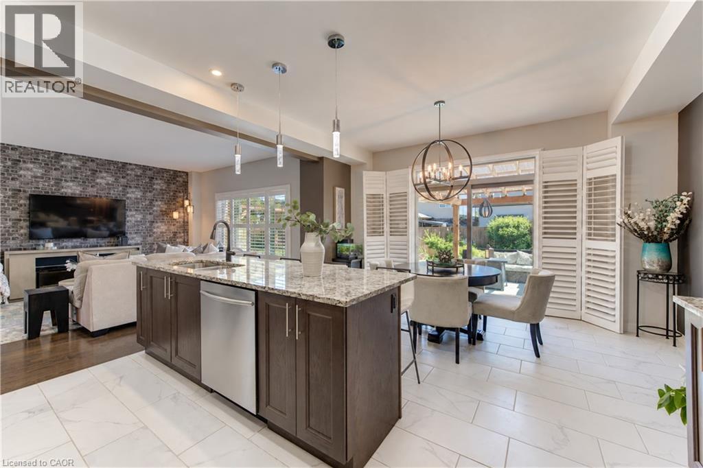Kitchen island with granite countertop and stainless steel appliances - 428 Freure Drive, Cambridge, ON
