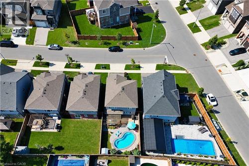 Aerial perspective showcasing residential properties with pitched roofs, individual backyard spaces, and paved street access - 428 Freure Drive, Cambridge, ON 