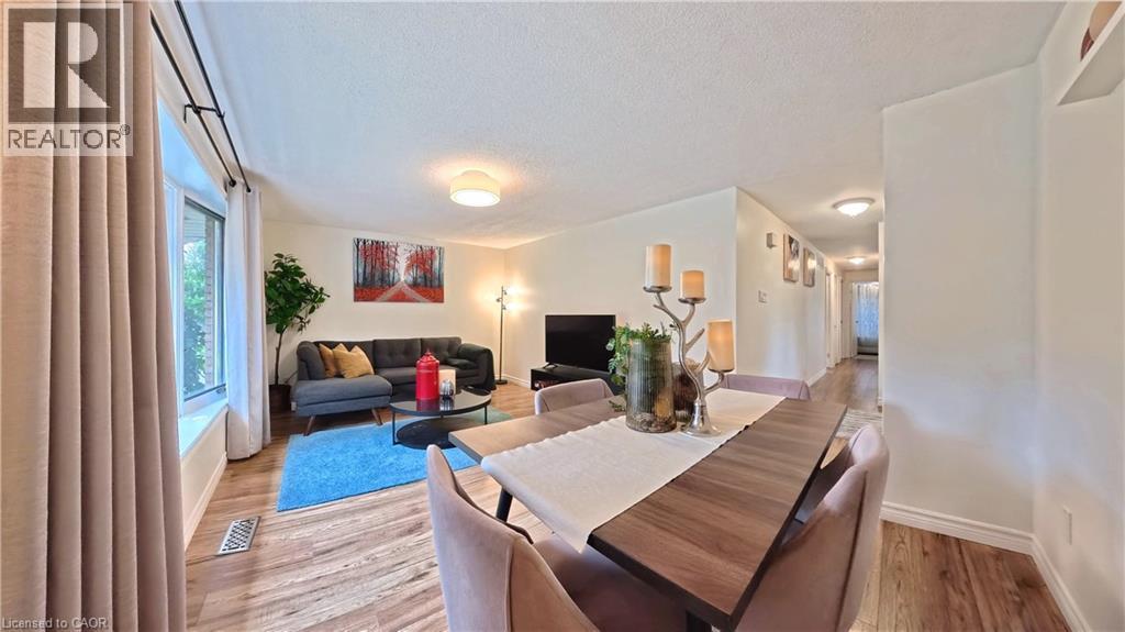Wood-finish flooring throughout, bay window with curtain rods, and recessed wall shelving - 380 Grangewood Drive, Waterloo, ON