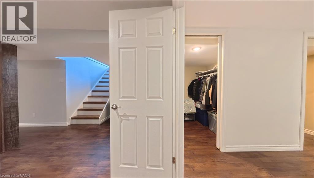 Wood-finish flooring, white paneled door, and recessed lighting - 380 Grangewood Drive, Waterloo, ON