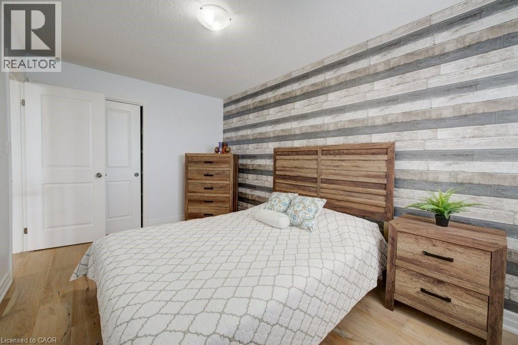 Wood-finish flooring present throughout the space - 300 Watervale Crescent, Kitchener, ON