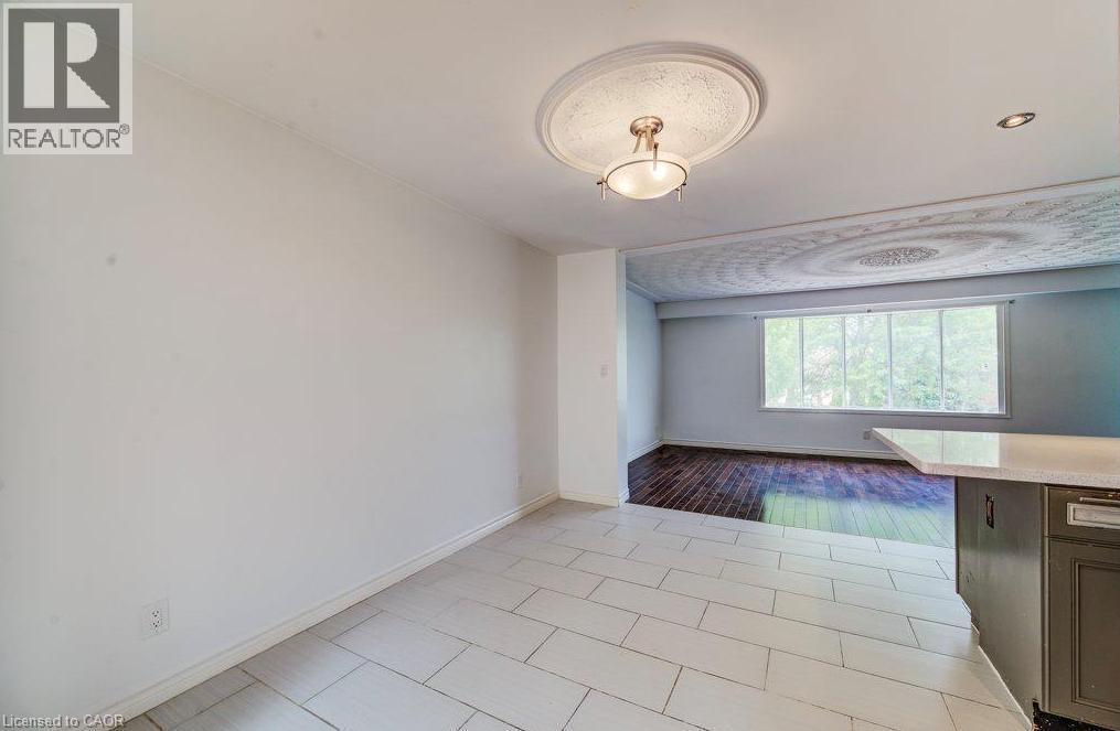 White tile flooring, decorative ceiling medallion, recessed lighting, large window, dark wood-finish flooring - 109 White Oak Place, Waterloo, ON - Indoor Photo Showing Other Room
