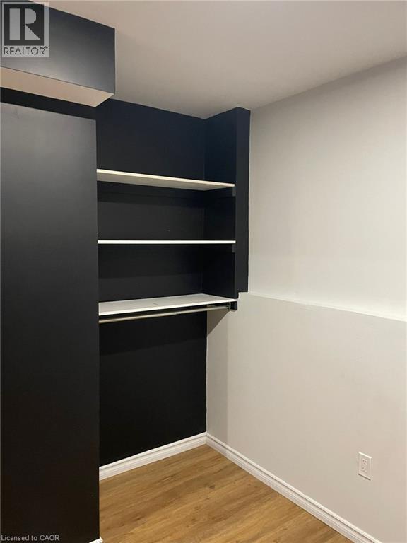 Built-in closet system with shelving and hanging rod - 47 Queensway Drive, Strathroy, ON - Indoor Photo Showing Other Room