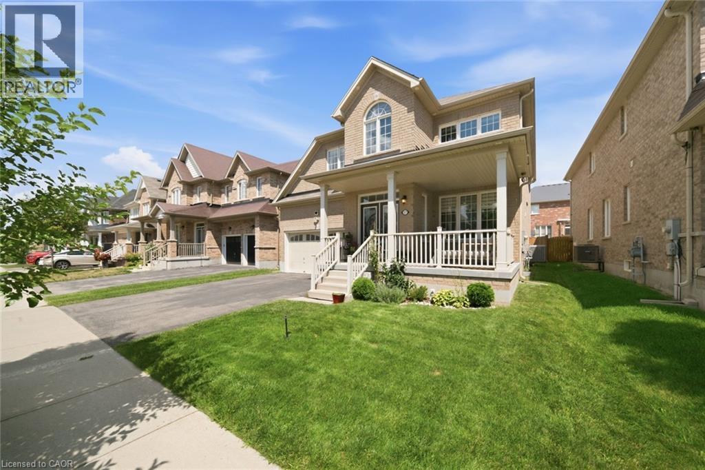 Brick exterior with a covered front porch featuring white railings - 57 Cheevers Road, Brantford, ON - Outdoor With Deck Patio Veranda With Facade