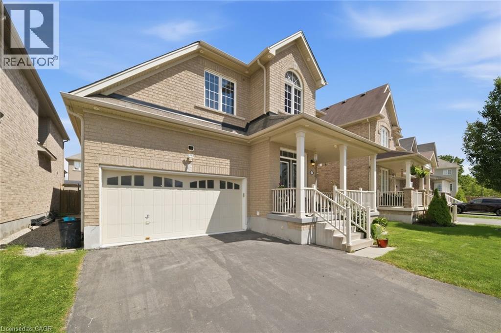 Brick exterior with a covered front porch featuring white railings and columns - 57 Cheevers Road, Brantford, ON - Outdoor