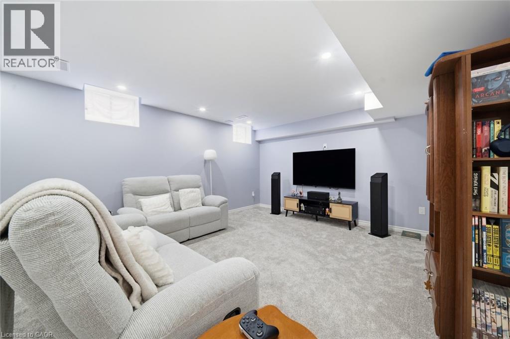 Recessed lighting illuminates the carpeted floor and light-toned walls - 57 Cheevers Road, Brantford, ON - Indoor
