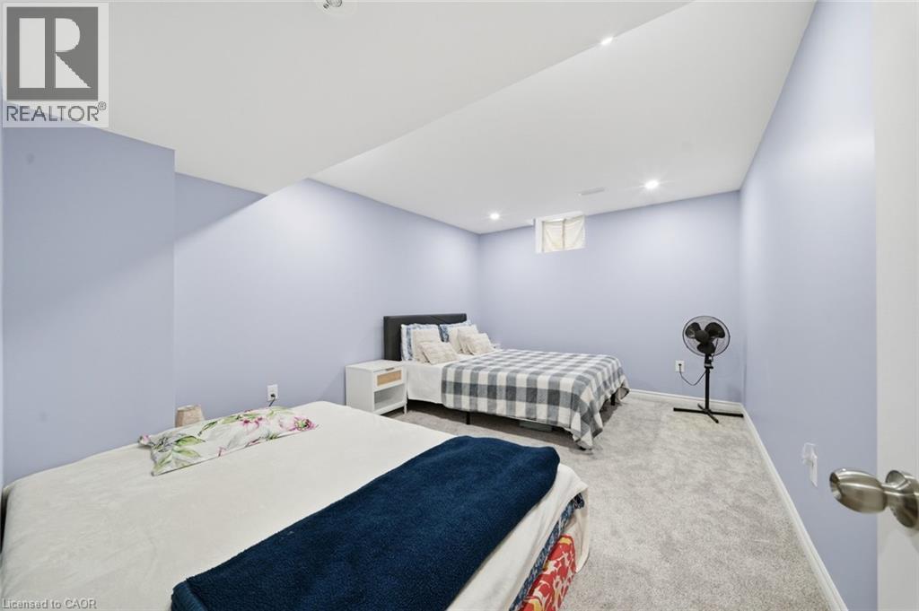 Recessed lighting, light blue wall paint, gray carpet flooring, and a single window - 57 Cheevers Road, Brantford, ON - Indoor Photo Showing Bedroom